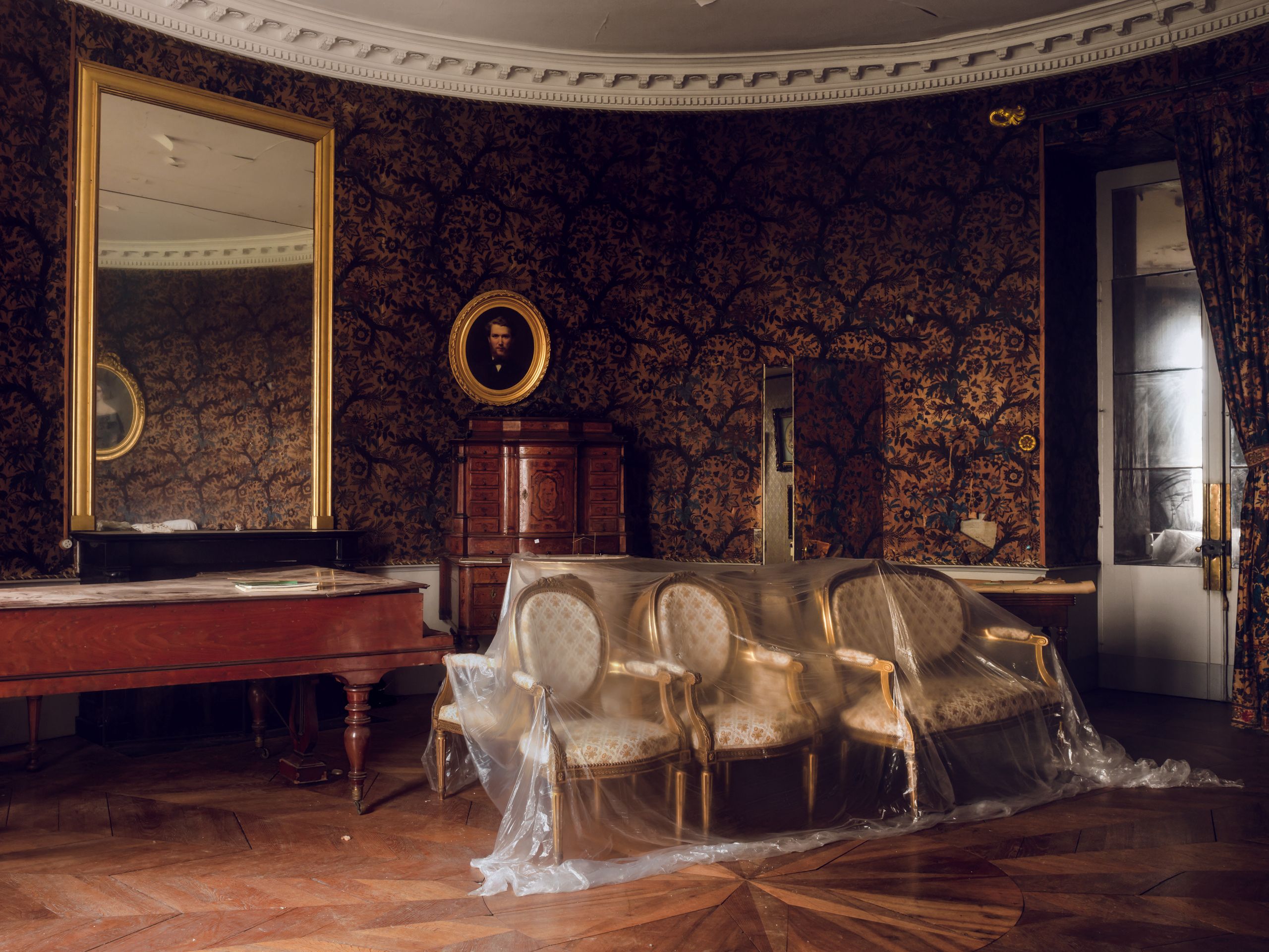 The walls of the oval drawing room in Château de Saulières are lined with a chintz wallpaper gifted by Charles X along...