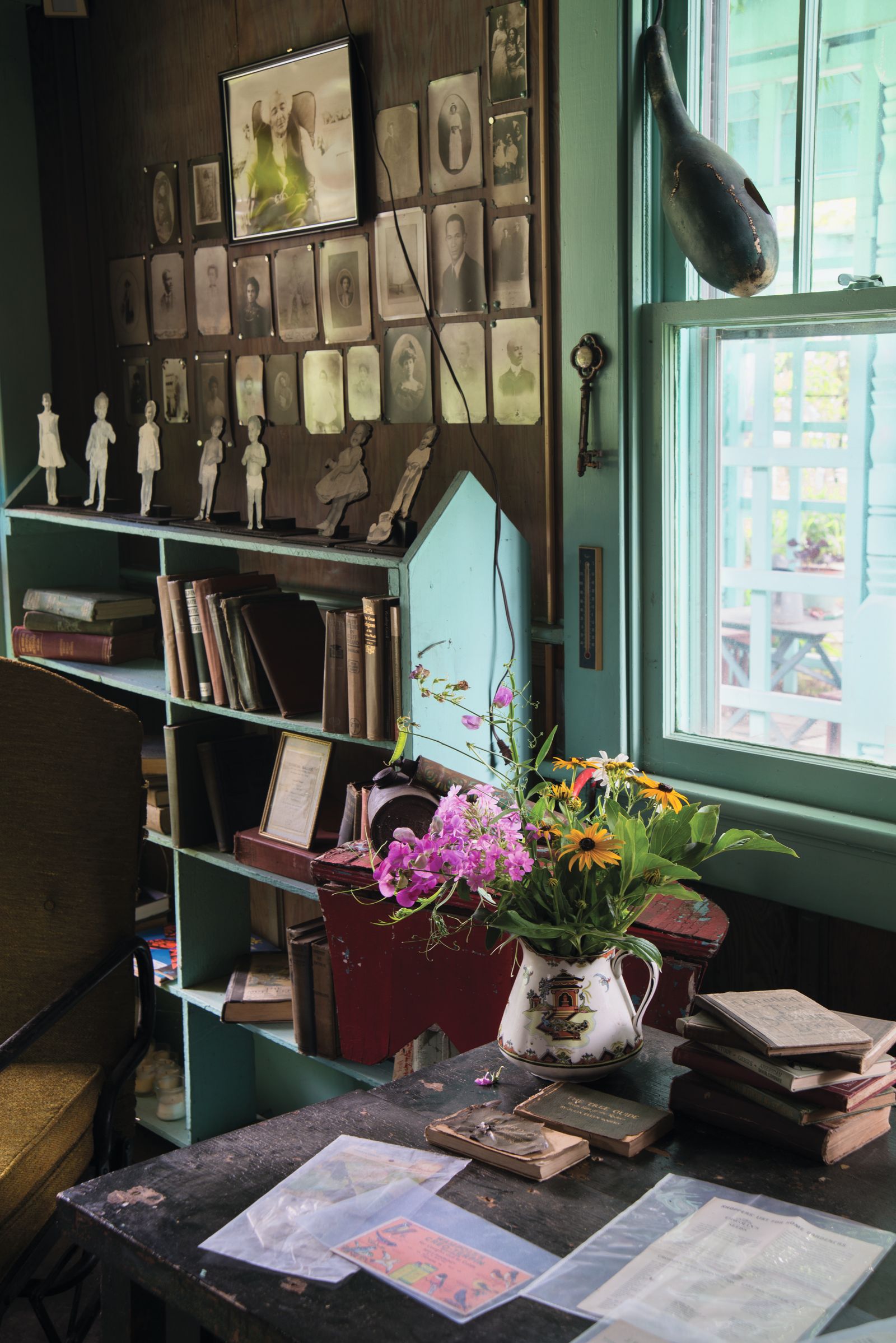Image may contain Book Publication Furniture Person Desk Table Indoors Interior Design Plant Potted Plant and Art