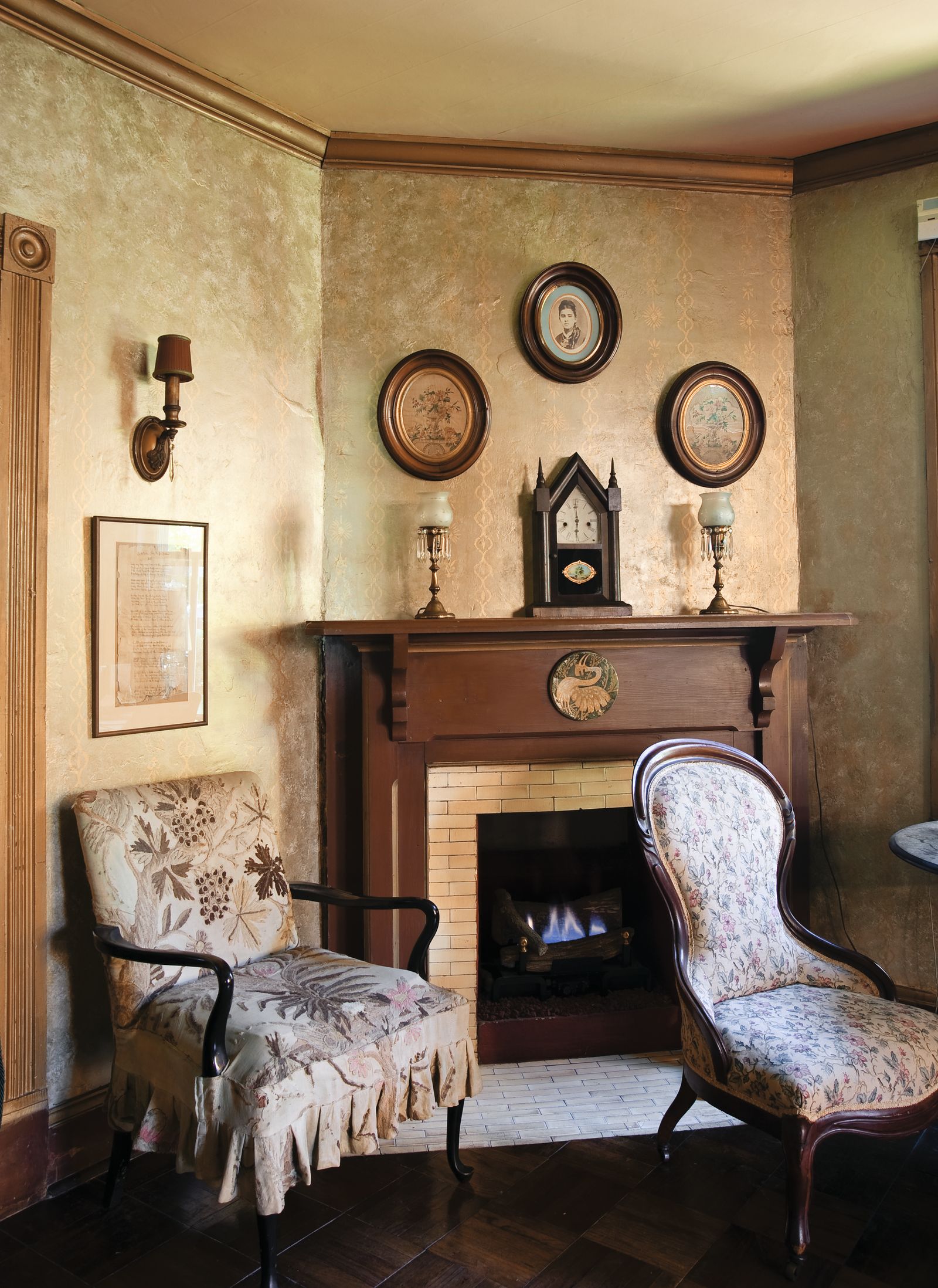 Image may contain Fireplace Indoors Lamp Chair Furniture Art Painting Hearth Architecture Building and Living Room