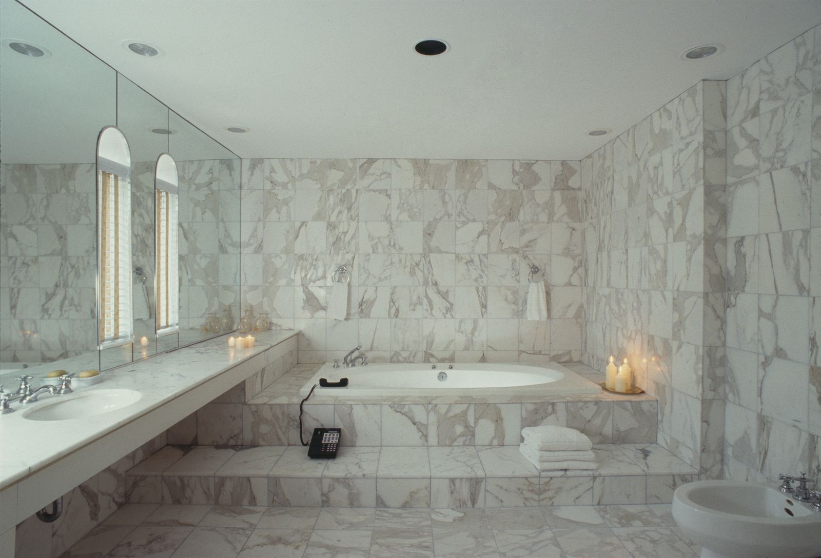 Image may contain Bathing Tub Bathtub Person Sink Sink Faucet Indoors Interior Design Candle and Floor