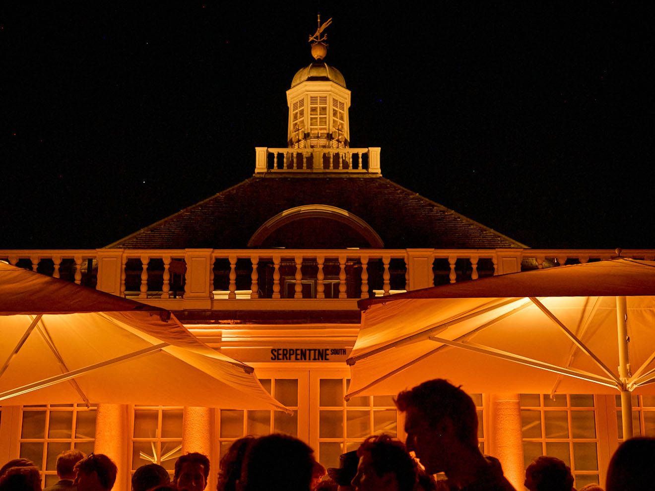 Image may contain Lighting Architecture Building Outdoors Shelter Urban Adult Person Wedding Nature and Night